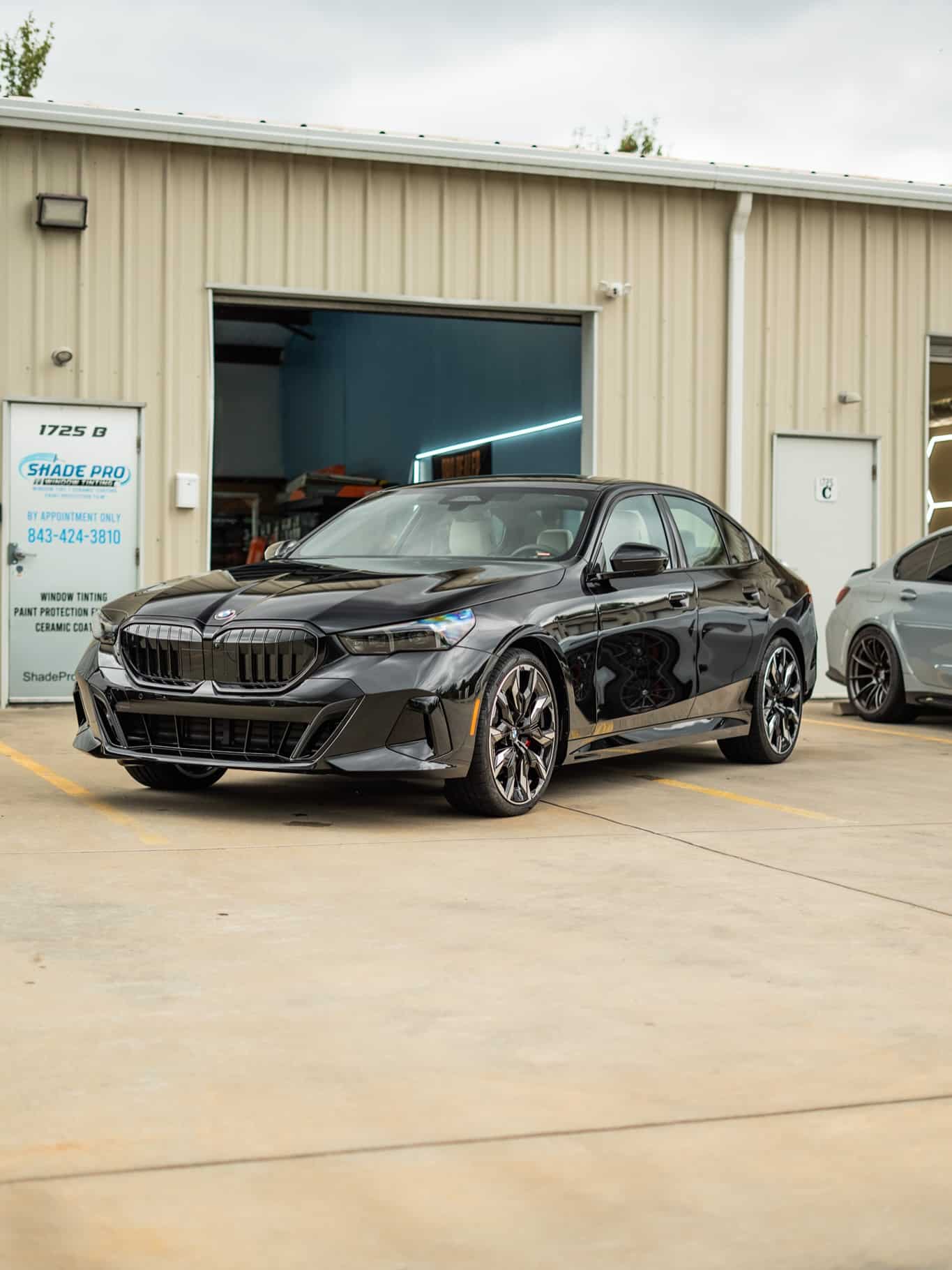 Ceramic coated black BMW 5 Series outside the shop