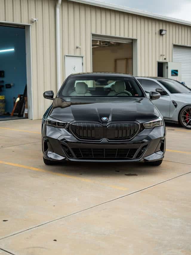 Front view of a ceramic coated black BMW 5 Series