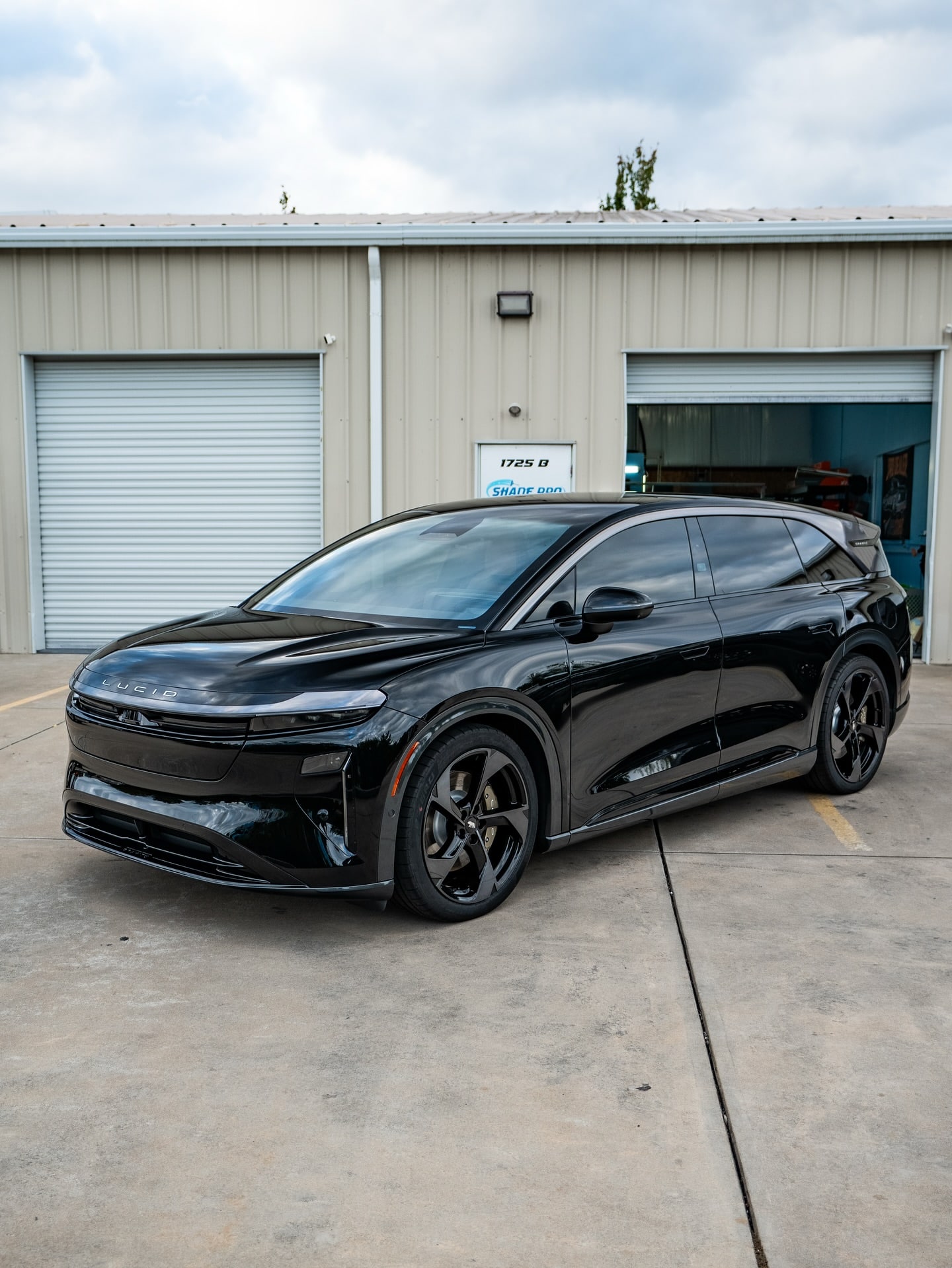 Ceramic coated black Lucid Gravity outside the shop bay